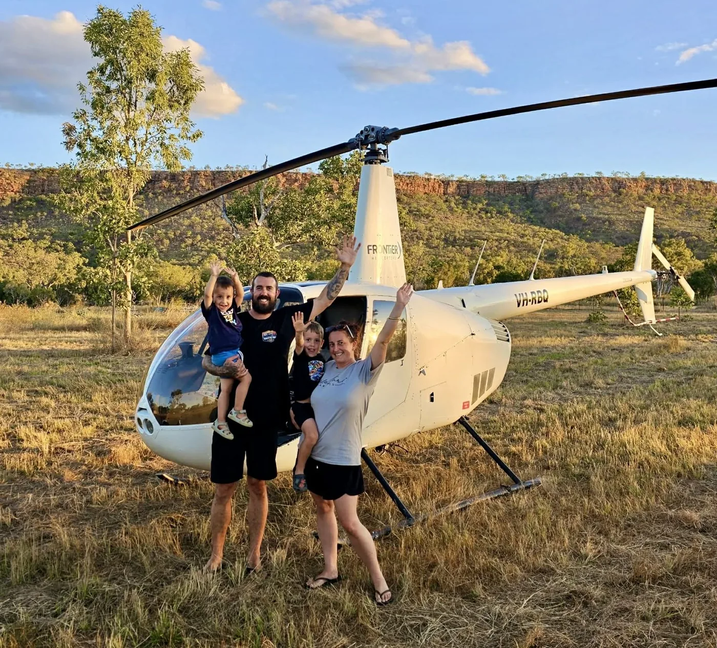 Craig with his family in front of a helicopter in the Kimberley